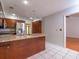 Well-lit kitchen featuring granite counters, a stainless steel refrigerator and tile flooring at 3177 Westfield Ne Way, Roswell, GA 30075
