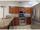 Well-equipped kitchen featuring stainless steel appliances, granite countertops and wood cabinetry at 3177 Westfield Ne Way, Roswell, GA 30075