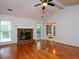 Inviting living room with a brick fireplace, fan, gleaming hardwood floors and lots of natural light at 3177 Westfield Ne Way, Roswell, GA 30075