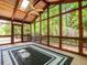 Light-filled screened porch with vaulted wood ceilings, views of the private wooded backyard at 3177 Westfield Ne Way, Roswell, GA 30075
