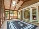 Enclosed screened porch with high ceilings and view to backyard and house at 3177 Westfield Ne Way, Roswell, GA 30075