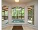 Bright sunroom with beautiful, large windows overlooking a lush, green backyard at 3177 Westfield Ne Way, Roswell, GA 30075
