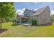 Expansive backyard showing the home's covered patio, plush lawn, and manicured landscaping at 3264 Andante Ne Dr, Marietta, GA 30062