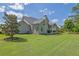 Well-maintained backyard showcasing a spacious lawn and the home's rear exterior at 3264 Andante Ne Dr, Marietta, GA 30062