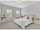 Bright bedroom with a comfortable bed, a stylish vanity and ample natural light from two large windows at 3264 Andante Ne Dr, Marietta, GA 30062
