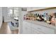 Butler's pantry with white cabinets, counter space, and wine storage, connecting the kitchen and dining area at 3264 Andante Ne Dr, Marietta, GA 30062