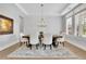 Elegant dining room with a tray ceiling, wainscoting, and a large window with plantation shutters at 3264 Andante Ne Dr, Marietta, GA 30062