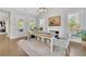 Bright dining room features a fireplace, modern lighting, and access to the outdoor with natural light and wood floors at 3264 Andante Ne Dr, Marietta, GA 30062