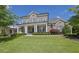 Beautiful two-story brick home with lush landscaping and a charming covered front porch with elegant columns at 3264 Andante Ne Dr, Marietta, GA 30062