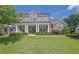 Stunning two-story brick home with a manicured lawn and a welcoming front porch with stately columns at 3264 Andante Ne Dr, Marietta, GA 30062