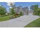 Spacious home with a long driveway leading to a three-car garage, surrounded by well-maintained landscaping at 3264 Andante Ne Dr, Marietta, GA 30062