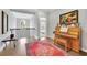 Bright hallway with hardwood floors and a vintage piano, creating an inviting and elegant atmosphere at 3264 Andante Ne Dr, Marietta, GA 30062