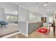 Upstairs hallway featuring hardwood floors, natural light, and views into adjacent sitting room at 3264 Andante Ne Dr, Marietta, GA 30062