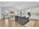 Bright kitchen featuring white cabinets, stainless appliances, and a large kitchen island with seating and open display area at 3264 Andante Ne Dr, Marietta, GA 30062