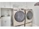 Laundry room featuring a stainless steel sink and modern, front-load washer and dryer units at 3264 Andante Ne Dr, Marietta, GA 30062