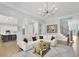 Open-concept living room featuring hardwood floors, white sofa, and an area rug, blending style and comfort at 3264 Andante Ne Dr, Marietta, GA 30062