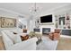 Bright living room with custom built-ins, fireplace, and a modern chandelier over a comfortable seating area at 3264 Andante Ne Dr, Marietta, GA 30062
