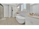 Bright main bathroom boasts a soaking tub, separate vanities, clean lines, and natural light, creating a spa-like feel at 3264 Andante Ne Dr, Marietta, GA 30062