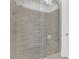 Beautifully tiled walk-in shower featuring a built-in bench, neutral color palette and glass enclosure at 3264 Andante Ne Dr, Marietta, GA 30062