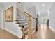 Inviting staircase with wood treads, black iron railings, and a view towards the bright entryway at 3264 Andante Ne Dr, Marietta, GA 30062