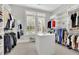Large walk-in closet with custom shelving, drawers, an island, and a window that provides natural light at 3264 Andante Ne Dr, Marietta, GA 30062