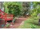 Charming backyard showcasing vibrant flowers, a playset, and ample green space for outdoor activities at 4085 Tritt Homestead Dr, Marietta, GA 30062