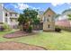 View of a backyard featuring a well-maintained lawn and garden beds, offering a serene outdoor space at 4085 Tritt Homestead Dr, Marietta, GA 30062