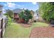 Spacious backyard with mature trees, lush green grass, and mulched play areas for outdoor enjoyment at 4085 Tritt Homestead Dr, Marietta, GA 30062