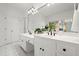 Bright bathroom features double sinks, ample counter space, a window, and a large mirror at 4085 Tritt Homestead Dr, Marietta, GA 30062