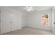 Well-lit bedroom with double closet doors, neutral carpet and ceiling fan at 4085 Tritt Homestead Dr, Marietta, GA 30062