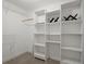 Walk-in closet with custom built-in shelving and carpeting at 4085 Tritt Homestead Dr, Marietta, GA 30062