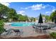 A serene view of the community pool and patio, complete with lounge chairs and shade umbrellas at 4085 Tritt Homestead Dr, Marietta, GA 30062