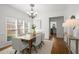 Elegant dining room with modern chandelier, hardwood floors, and abundant natural light at 4085 Tritt Homestead Dr, Marietta, GA 30062