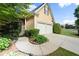 Driveway leading to a two-car garage, complemented by mature landscaping at 4085 Tritt Homestead Dr, Marietta, GA 30062