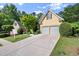 Traditional home featuring a well-manicured lawn, mature landscaping, and a two-car garage at 4085 Tritt Homestead Dr, Marietta, GA 30062