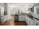 Modern kitchen featuring white cabinets, stainless steel appliances, and hardwood flooring at 4085 Tritt Homestead Dr, Marietta, GA 30062