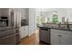 Kitchen featuring stainless steel appliances, including a refrigerator and dishwasher, plus hardwood floors at 4085 Tritt Homestead Dr, Marietta, GA 30062