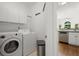 Bright laundry room features modern appliances, cabinets, and is conveniently near the kitchen at 4085 Tritt Homestead Dr, Marietta, GA 30062