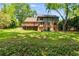 Large backyard with mature trees, spacious deck, and a charming home exterior at 5124 Vermack Rd, Dunwoody, GA 30338