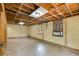 Basement area with painted walls, two windows, and floor needing refinishing at 5124 Vermack Rd, Dunwoody, GA 30338