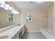 Neutral bathroom with double sink vanity, marble counters, and shower/tub at 5124 Vermack Rd, Dunwoody, GA 30338