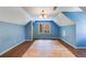 A light blue bedroom with unfinished floors, complemented by a unique light fixture at 5124 Vermack Rd, Dunwoody, GA 30338