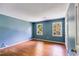 Bedroom with hardwood flooring, light-blue walls, and two windows at 5124 Vermack Rd, Dunwoody, GA 30338