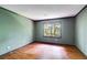 Empty bedroom with hardwood floors and a large window at 5124 Vermack Rd, Dunwoody, GA 30338