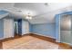 Blue bedroom with unfinished floors, complemented by a unique light fixture and double closets at 5124 Vermack Rd, Dunwoody, GA 30338