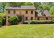 Charming brick two-story home with mature landscaping and a well-manicured lawn at 5124 Vermack Rd, Dunwoody, GA 30338
