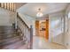 Welcoming foyer with hardwood stairs and decorative lighting fixture at 5124 Vermack Rd, Dunwoody, GA 30338