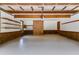 Clean garage interior with painted floors, wooden ceilings, and brick accent wall at 5124 Vermack Rd, Dunwoody, GA 30338