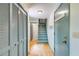 Hallway with hardwood floors, blue painted doors, closet, and staircase at 5124 Vermack Rd, Dunwoody, GA 30338