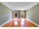 Bright living room with hardwood floors and views from the double windows at 5124 Vermack Rd, Dunwoody, GA 30338